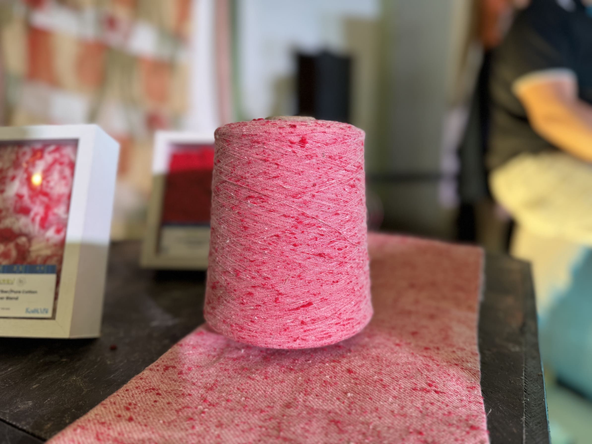 Undyed yarn spun from textile waste, ready to be woven into fabric