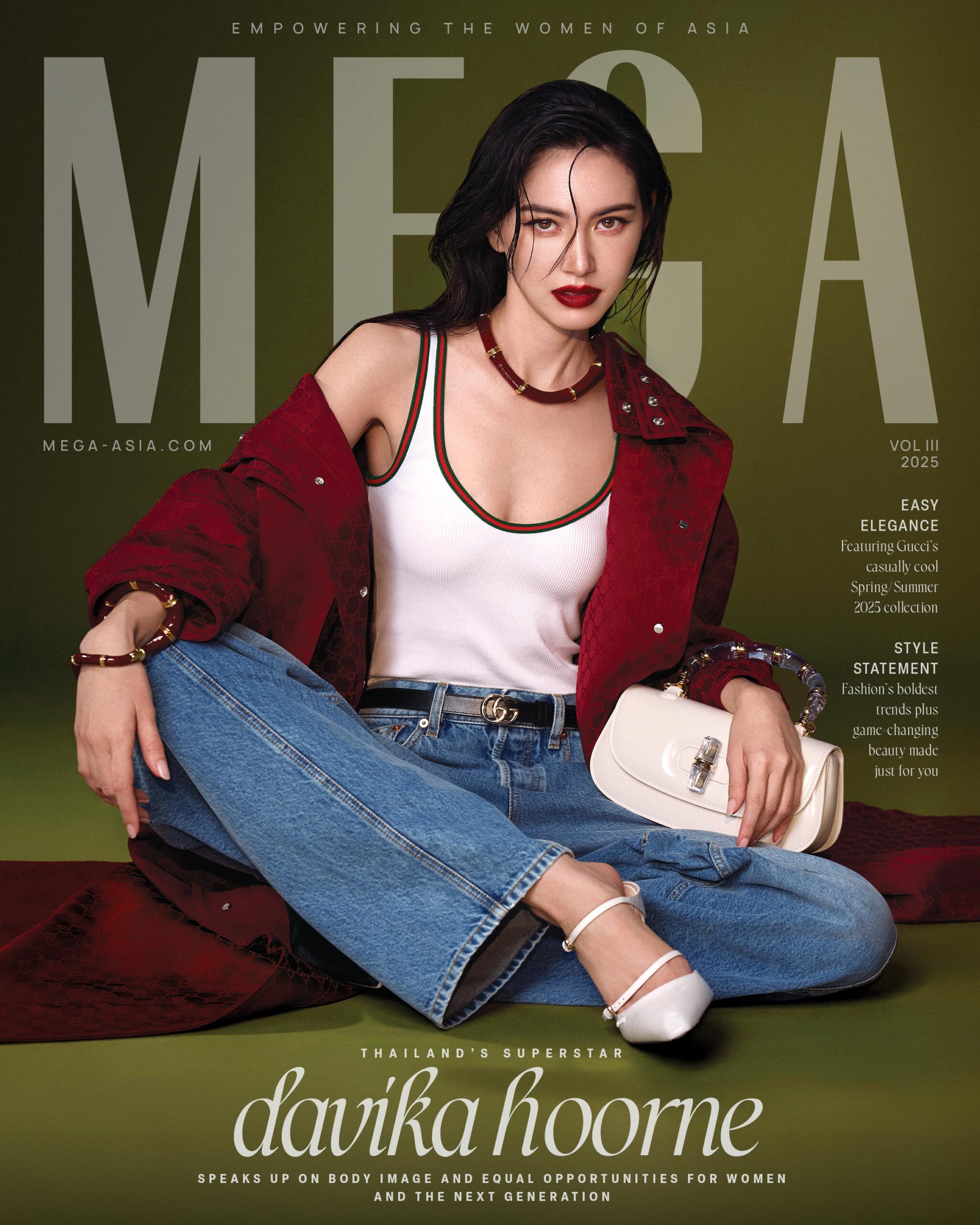 Davika Hoorne wears GUCCI red long sleeved high-neck logo oversized coat, GUCCI white jersey tank top, GUCCI balloon denim pants, GUCCI white wedged mules, with the white GUCCI Bamboo Diva handbag, GUCCI black logo belt, GUCCI enamel bamboo necklace, GUCCI bracelets