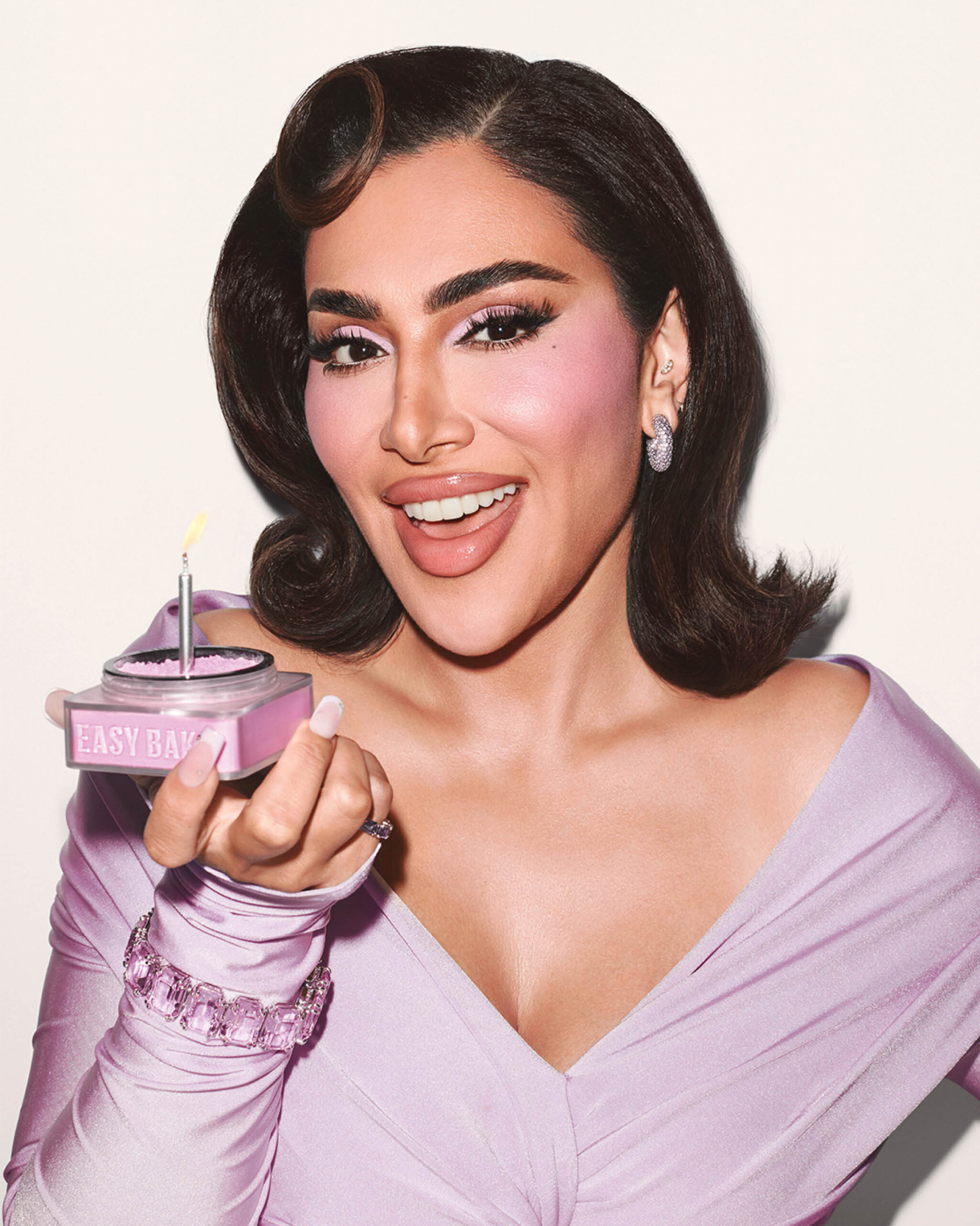 Huda Beauty's newest collection is a three product line-up that features an ube-inspired variant of the Easy Bake Loose Baking and Setting Powder, Blush Filter, and Faux Filler Lip Gloss